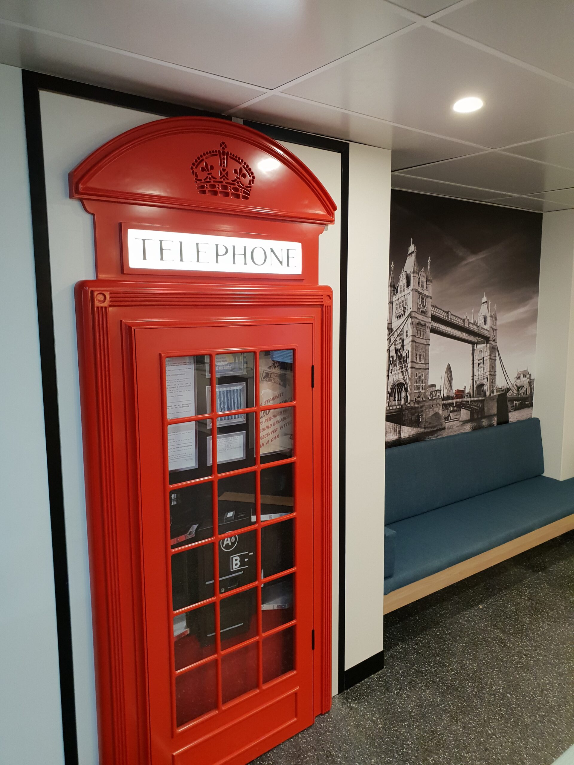 Custom joinery — UK phone booth feature with bench seat