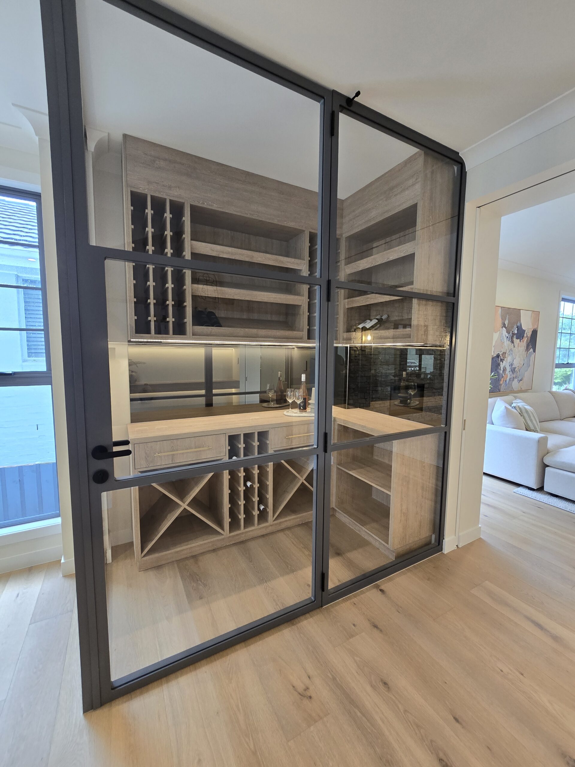 Custom wine cellar with X-shaped racking and glass doors